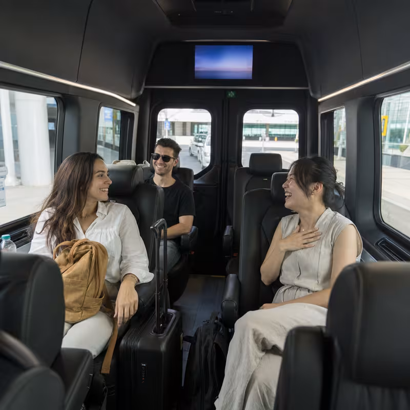 Passengers loading luggage while boarding an Dallas group shuttle