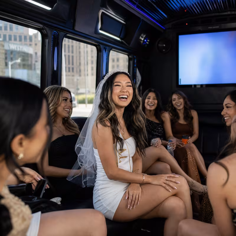 Party bus interior with wraparound leather seating and LED lighting in Dallas