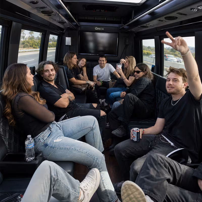 Group boarding a white charter bus for Concert Transportation transportation in Dallas