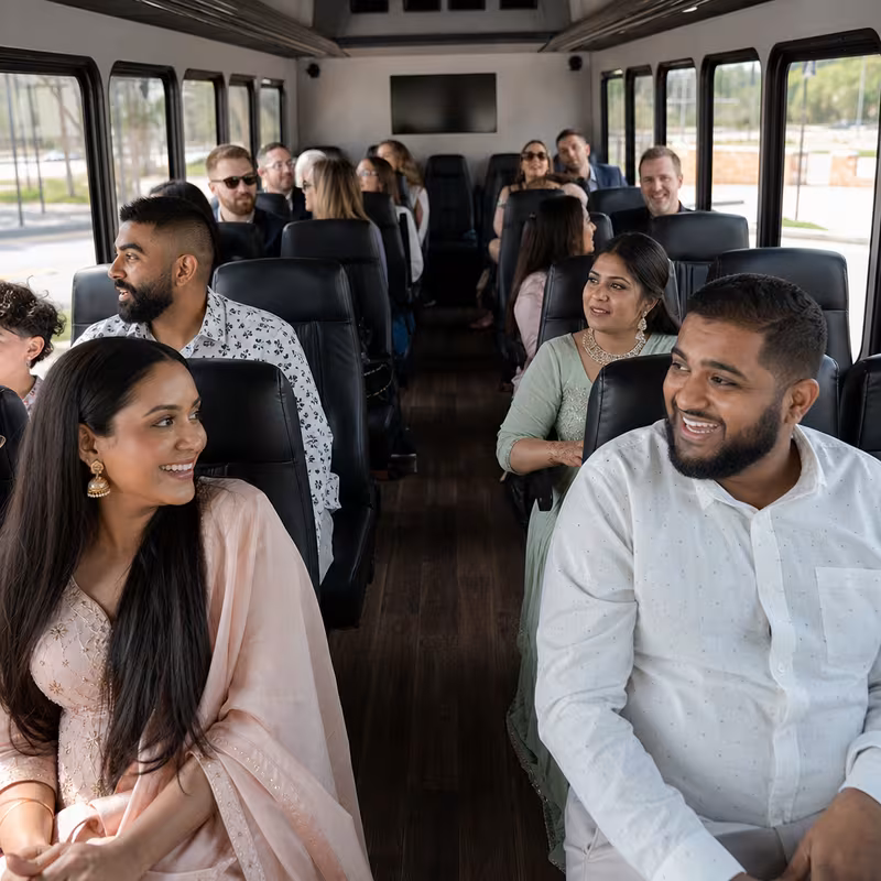 Group boarding a white charter bus for Private Event Transportation transportation in Dallas