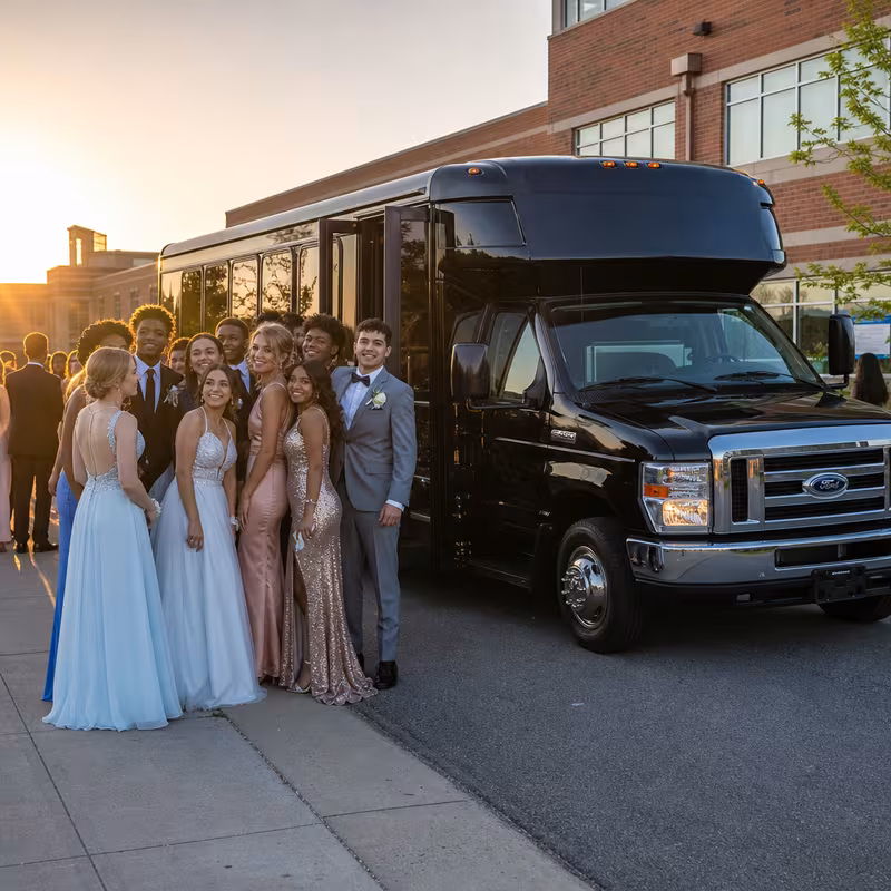 Group boarding a white charter bus for Prom & Homecoming Transportation transportation in Dallas
