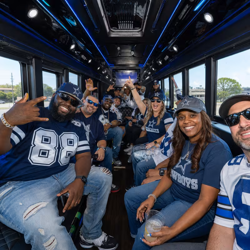 Group boarding a white charter bus for Sporting Event Transportation transportation in Dallas