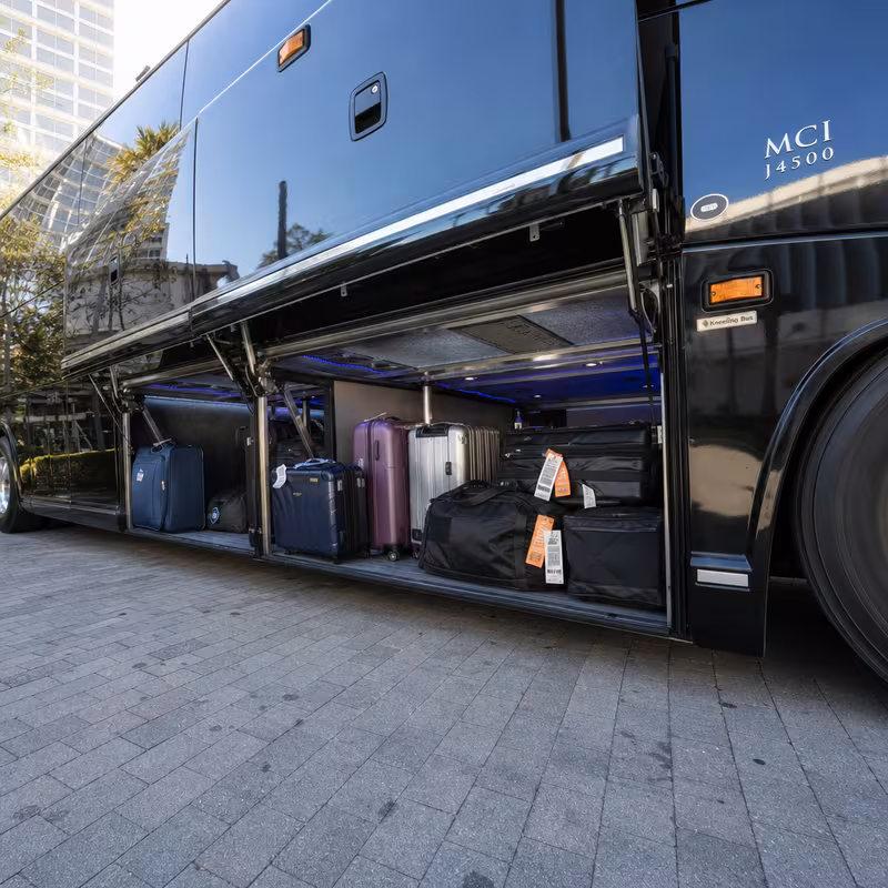 Party bus interior with wraparound leather seating and LED lighting in Dallas