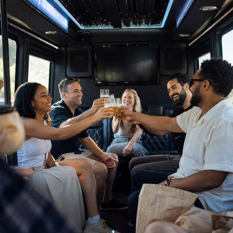 Group boarding a white charter bus for Winery & Brewery Tour Transportation transportation in Dallas