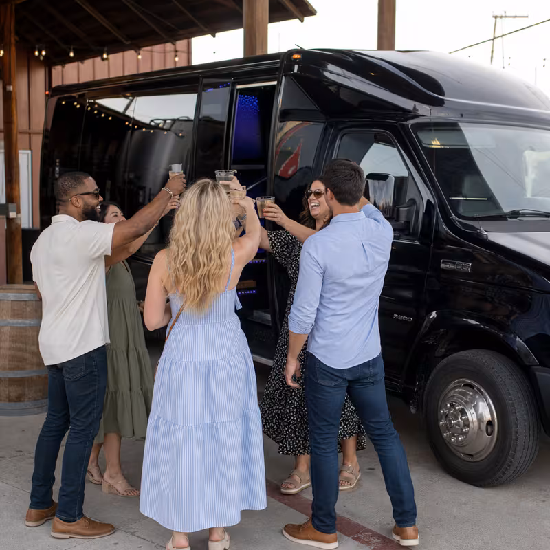 Passengers loading luggage while boarding an Dallas group shuttle